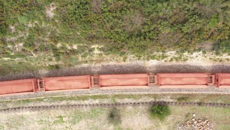 Freight-train-aerial-drone-view-over-wagons-with-shipment-on-a-railway